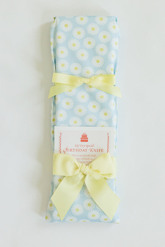 The Daisy Birthday Knife by Jubilee Keepsakes, wrapped in light blue daisy-patterned fabric with pale yellow ribbons and a “My Very Special Birthday Knife” label, is the perfect cake-cutting touch for any birthday party.