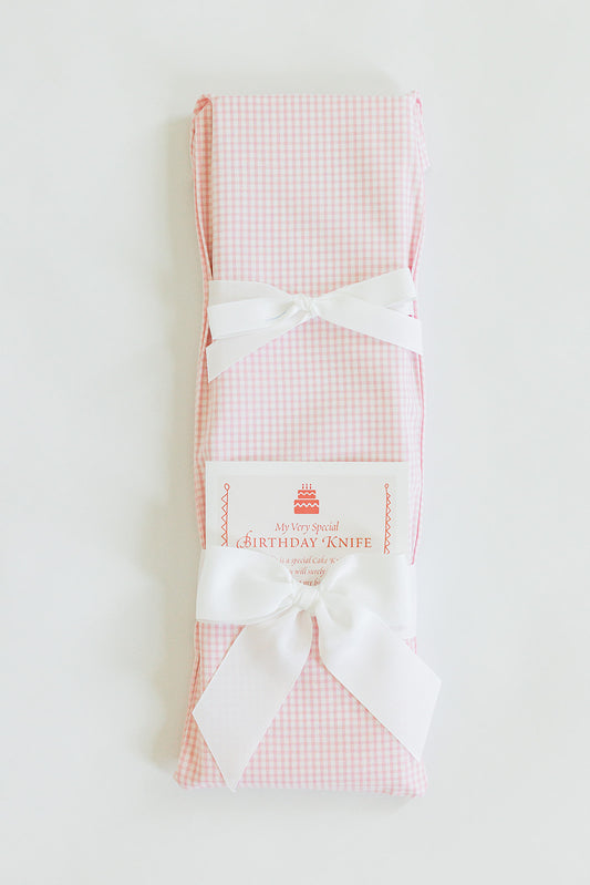 A Jubilee Keepsakes “Tiny Pink Gingham” gift-wrapped cake knife with two white bows and a “My Very Special Birthday Knife” tag—perfect for birthday traditions—displayed against a white background.